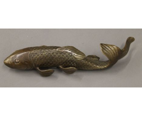 A patinated brass model of a fish