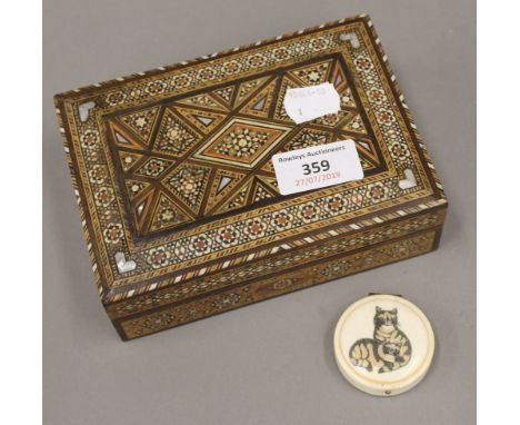 A bone patch mirror, decorated with two cats, together with a North African inlaid box