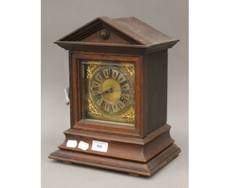 A 19th century oak cased German Junghans mantle clock, the signed movement striking on a gong, the case architectural