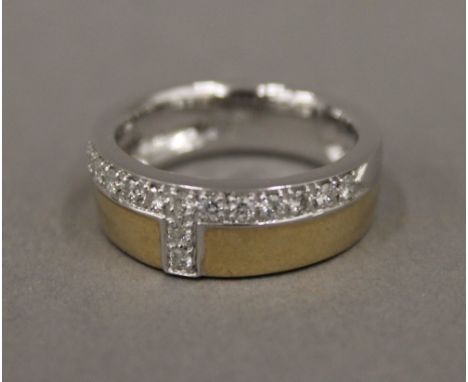 A 14 K two tone gold and diamond ring (7.4 grammes)