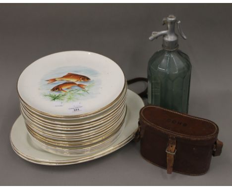A French ceramic fish decorated service by Gien, comprising: sixteen plates and a pair of platters, together with a vintage C