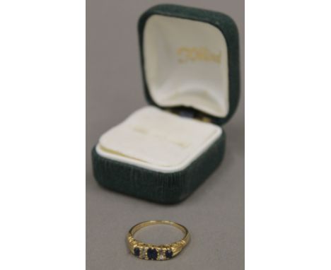 An 18 ct gold diamond and sapphire set ring, size P (4 grammes total weight)