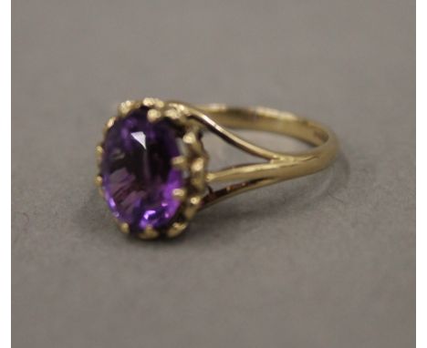 A 9 ct gold amethyst set ring, modern, size N/O (3 grammes total weight)