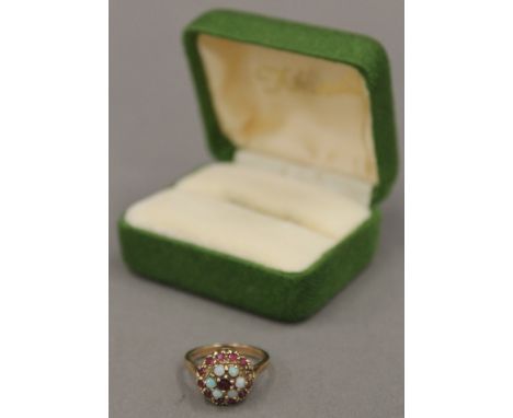 A 9 ct gold opal and possibly spinel set cluster ring, size M (4 grammes total weight)