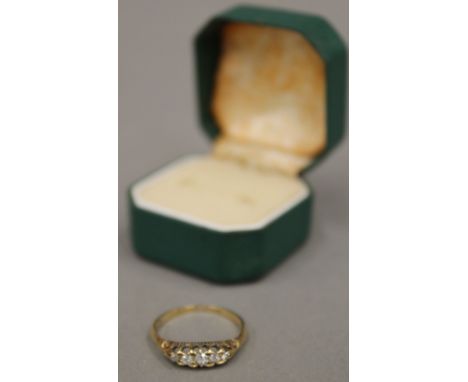 An 18 ct gold diamond set five stone ring, size P (3 grammes total weight)