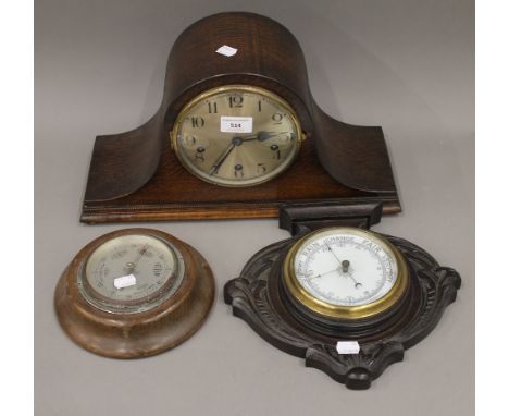 An early 20th century oak mantle clock and two barometers