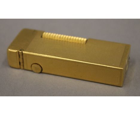 A gold plated Dunhill lighter