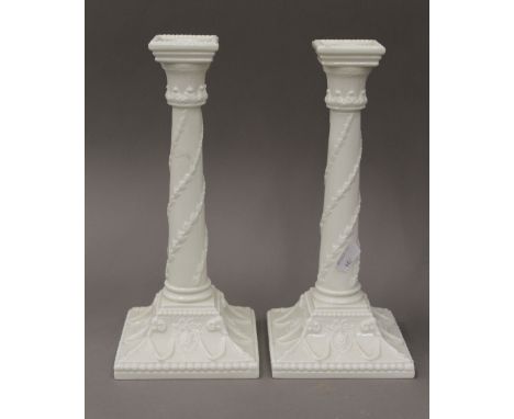 A pair of Royal Worcester porcelain candlesticks