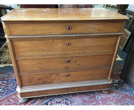 A 19th century Continental walnut commode/chest of four long drawers, standing on flattened bun feet, 114 cm wide x 96 cm hig