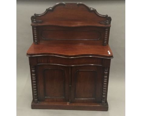 A Victorian mahogany chiffonier with shelf back and panelled cupboard doors