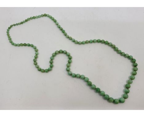 A string of graduated green jade beads, the largest diameter 10mm, length approx. 76cm.&nbsp;