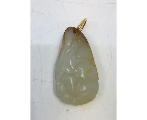 A Chinese carved celadon jade pendant with russet inclusions&nbsp;