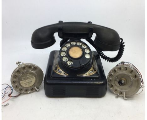 A vintage black bell telephone (Belglque, M F G Company, 2712-A-RB) together with spare parts