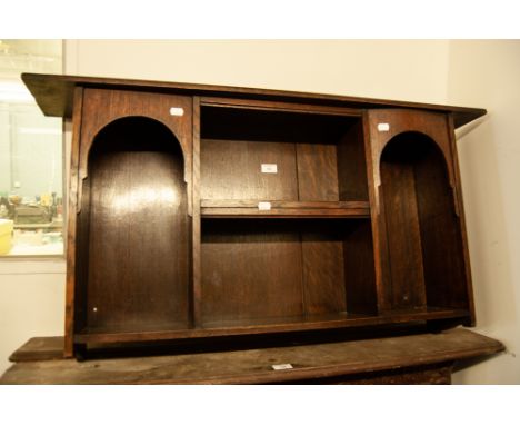 1930s OAK LIBERTY & CO DISPLAY STAND WITH ORIGINAL ENAMEL LABEL, THE EXTENDED TOP OVER TWO ARCHED SIDE COMPARTMENTS AND TWO C