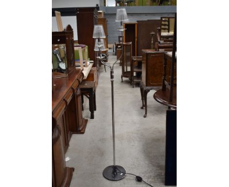 A modern chrome effect three branch standard lamp