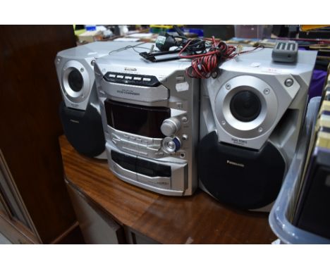 A Panasonic CD Stereo System , with 5 CD changer and twin cassette decks, model SA-AK18, includes speakers.
Appears in good c