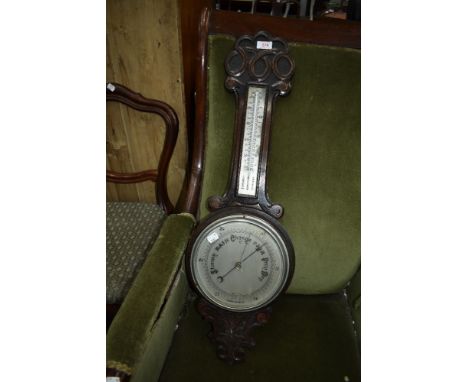 An early 20th Century oak cased aneroid barometer with thermometer scale to stem