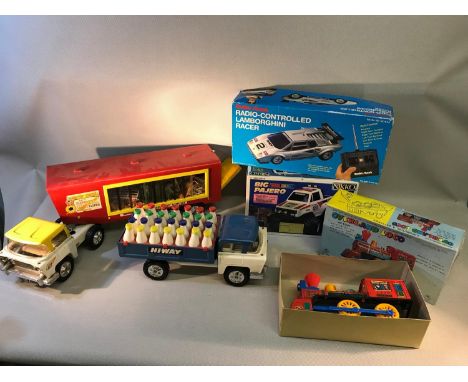 A lot of vintage toys to include overland loco, circus truck with animals, milk truck & two radio controlled cars together wi