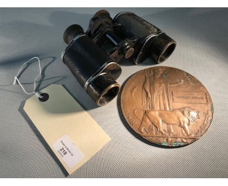 A first world war death plaque together with vintage binoculars 