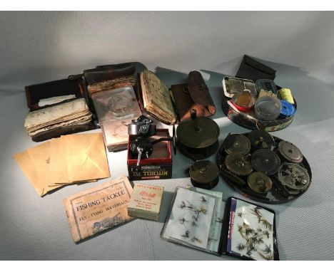 A lot of various fishing items to include vintage brass reels, Mitchell 304 reel, numerous wallets (1 made by Farlow) filled 