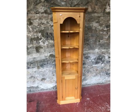 Light pine wood corner cabinet. Fitted with shelving and single door. Measures 78.5x51x25cm 