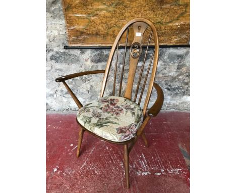 Ercol spindle back arm chair, Designed with a central swan carving 