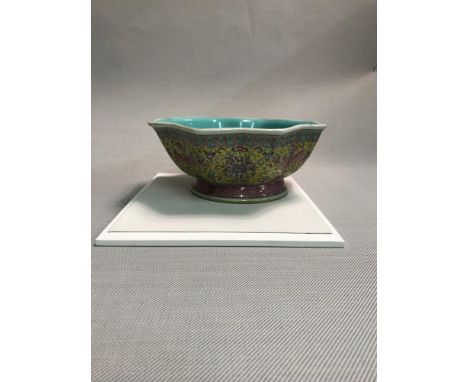 A Chinese porcelain yellow ground octagonal shaped bowl, bearing Qianlong seal mark, decorated with lotus scroll. 19.5cm diam