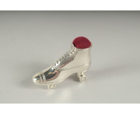 A SILVER ROLLER SKATE PIN CUSHION. 3.5cm