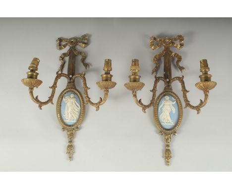 A PAIR OF GILT METAL TWO LIGHT WALL SCONCES with oval  Wedgwood Jasper plaques. 14ins long.