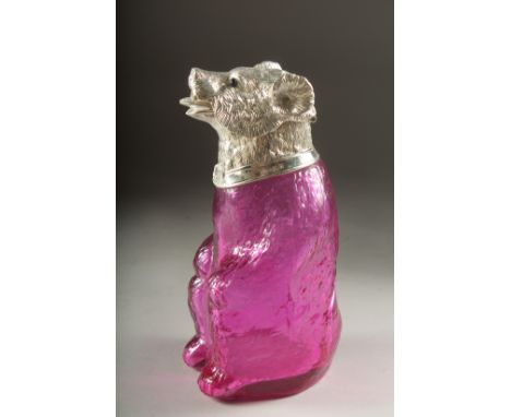 A GLASS CLARET JUG formed as a bear with silver plated head. 7ins high.