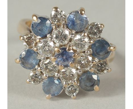 A WHITE GOLD DIAMOND AND SAPPHIRE CLUSTER RING in a box.