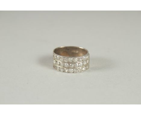 AN 18CT WHITE GOLD TRIPLE ROW DIAMOND RING.