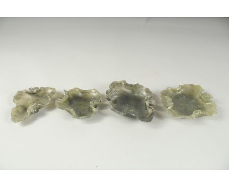 A SET OF FOUR LEAF SHAPED JADE DISHES.
