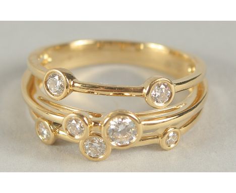 A GOOD 18CT YELLOW GOLD SEVEN STONE DIAMOND RING. Size O in a box.