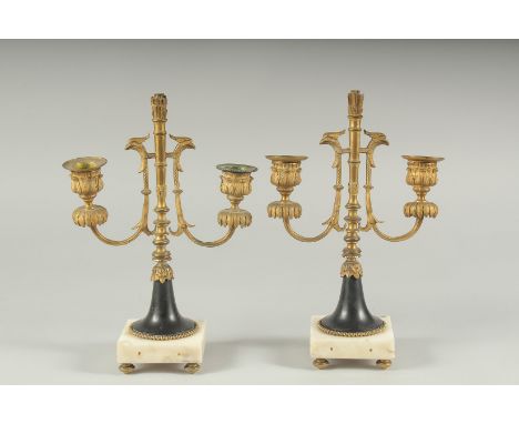 A GOOD PAIR OF ORMOLU TWO LIGHT CANDLESTICKS on square marble bases.  11ins high.