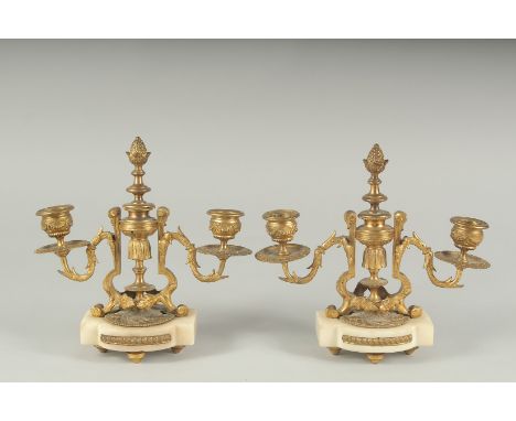 A GOOD PAIR OF  ORMOLU TWO LIGHT CANDLESTICKS on shaped marble bases.  8ins high.