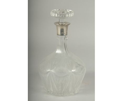 A HEAVY CUT GLASS DECANTER AND STOPPER with silver band.