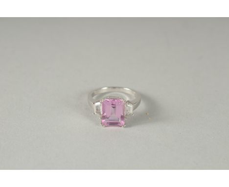 A 10K WHITE GOLD PINK STONE AND DIAMOND RING.