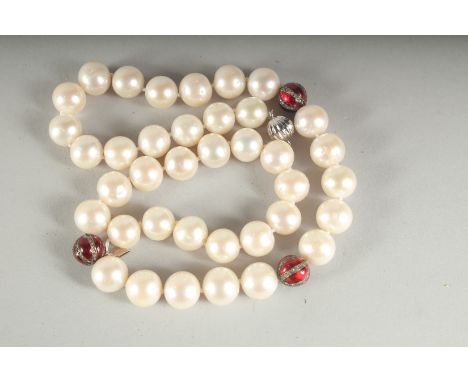 A STRING OF 38 PEARLS AND THREE DIAMOND AND ENAMEL BEADS.