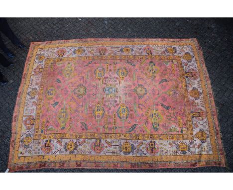 A LARGE AFGHAN CARPET  rust ground with stylised decoration 13ft 6ins x 10ft 4ins.