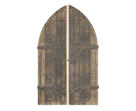 An impressive pair of Gothic-Revival oak doorsOf pointed-arch form, the frame of chamfered rails applied with boards held in 
