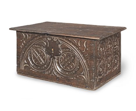 A small Charles II boarded oak box, circa 1660The hinged lid with shaped edge, above a front carved with a bold lunette frami