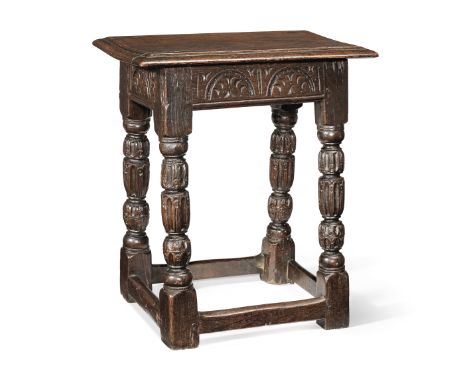An Elizabeth I oak joint stool, circa 1580Having an historically associated triple-reeded top, and leaf-filled lunette-carved