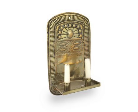 An 18th century sheet brass wall sconce, DutchThe arched backplate with a gadrooned border, and fitted with a rectangular tra