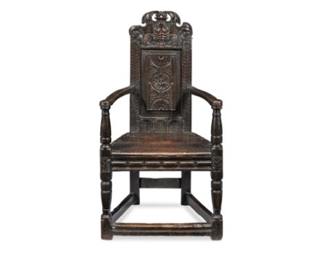 An extremely rare James I/Charles I joined oak caqueteuse armchair, Aberdeenshire, circa 1620-40Having a resplendent cresting