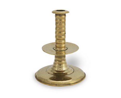 A mid- to late 17th century brass alloy trumpet-based socket candlestick, circa 1650-80With flange, the upper and lower stems