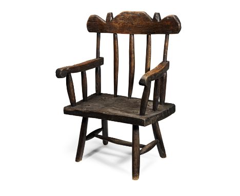 A 19th century oak primitive chair, probably Irish or possibly WelshOf comb-back form, with round-ended geometric shaped stay