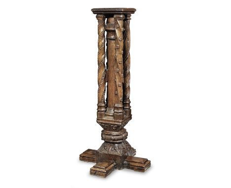 A late 15th century oak newel post, French, circa 1480-1500With later top and cruciform base to form a torchère, having a cen