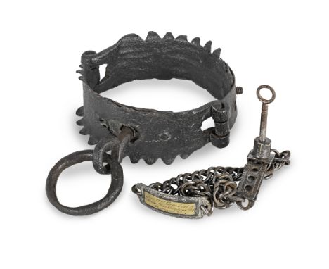 An iron manacle or collarHinged, and with notched edges forming spikes, with attached iron ring, 14cm maximum diameter, toget