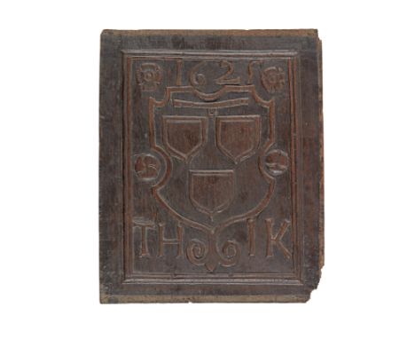 A James I/Charles I carved oak armorial panel, dated 1625Carved with a shield bearing three escutcheons beneath a yoke or col
